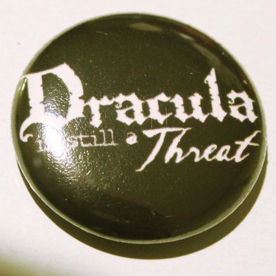 1" x 1" pin-dracula is still a threat logo