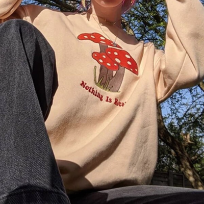 "nothing is real" mushroom sweatshirt