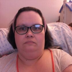 Me in glasses and grey striped nightgown